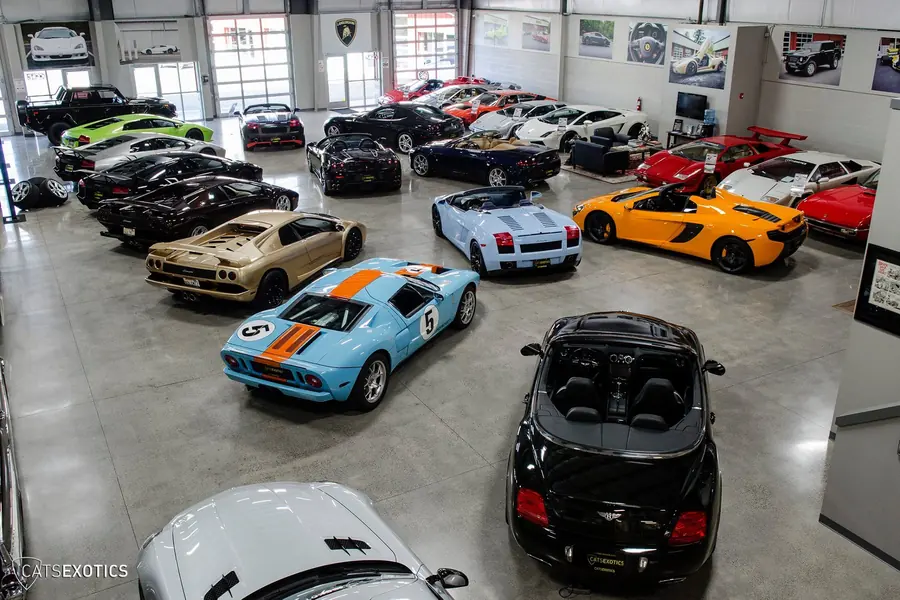 Premium car detail: Sala con autos deportivos limpios y alineados